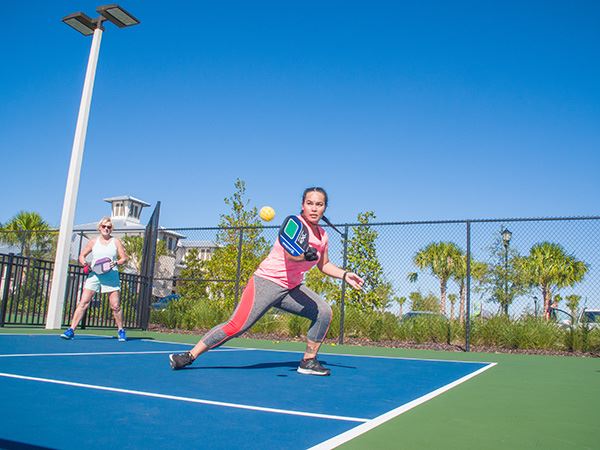 Woman playing pickleball on court in Waterset.